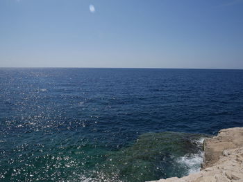 Scenic view of sea against clear blue sky