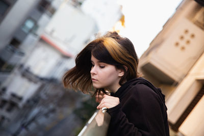 Portrait of young woman looking at camera