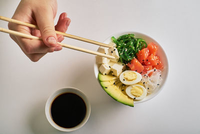 Midsection of person holding bowl