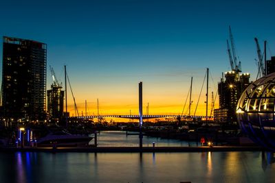 Boats in harbor at sunset