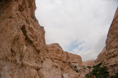 Low angle view of rock formations against sky