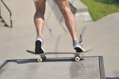 Low section of man skateboarding on skateboard