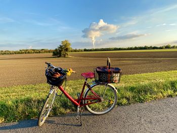 Bicycle on field against sky