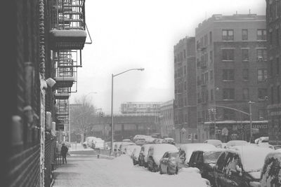 Snow covered buildings in city