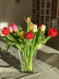 Close-up of red roses in vase on table