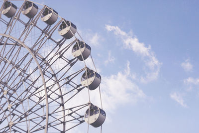 Low angle view of ferris wheel against sky