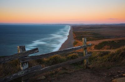 Scenic view of sea against clear sky during sunset