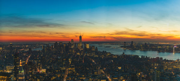 High angle view of buildings against cloudy sky during sunset