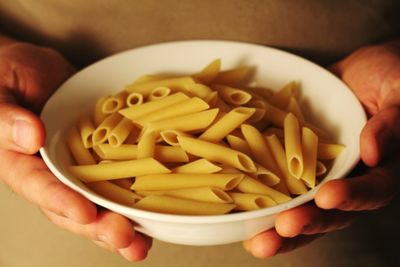 Midsection of person holding bowl