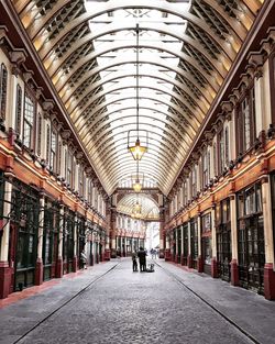 Men standing in market building