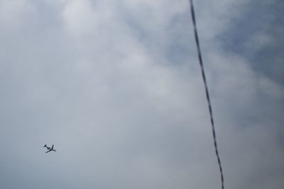 Low angle view of airplane flying in sky