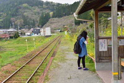 Woman walking on railroad track