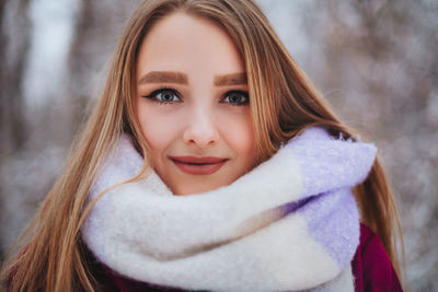 Portrait of smiling woman in snow