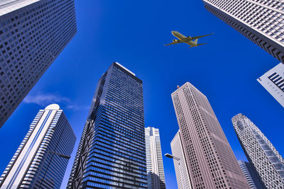 Low angle view of modern buildings against blue sky