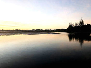 Scenic view of lake against sky during sunset