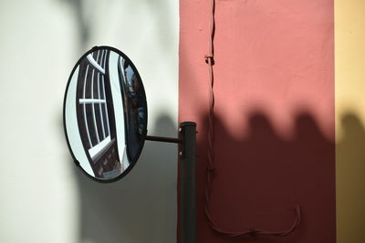Close-up of mirror against the wall with shadow