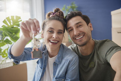Portrait of a smiling young couple holding hands