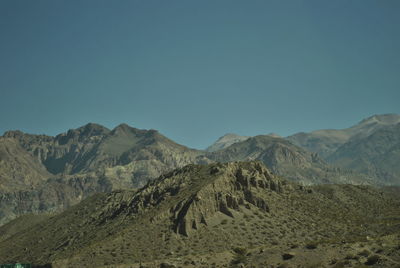 Scenic view of mountains against clear blue sky