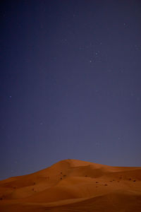 Scenic view of desert against sky at night