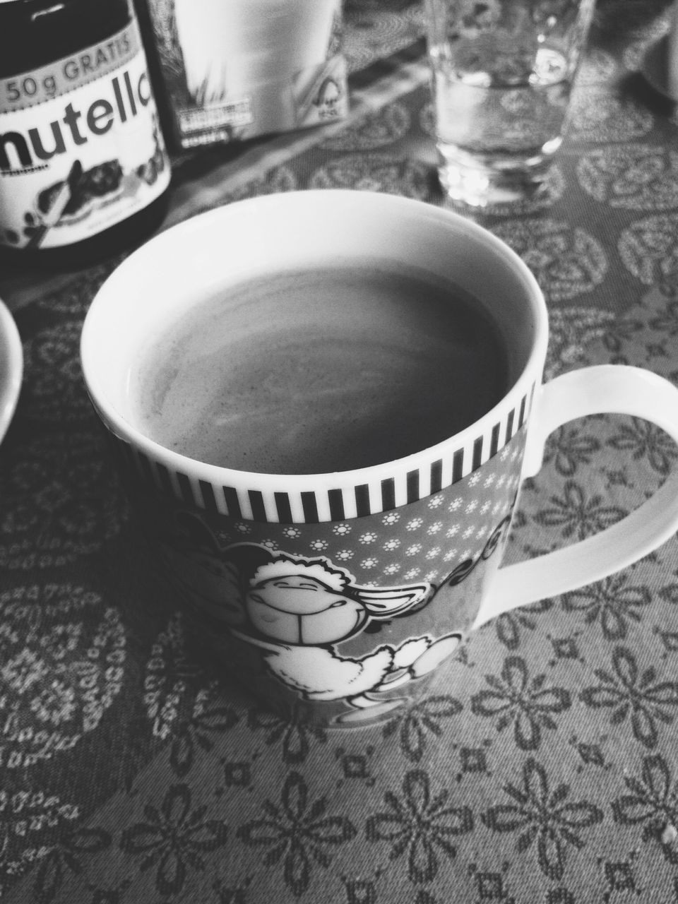 indoors, table, still life, drink, close-up, refreshment, high angle view, food and drink, no people, focus on foreground, text, western script, wood - material, coffee cup, metal, reflection, communication, glass - material, empty, day