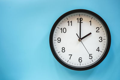 Low angle view of clock on wall