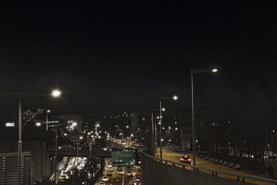 High angle view of illuminated street and buildings at night