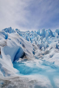 Scenic view of glacier against sky