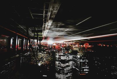 Illuminated lights against sky at night