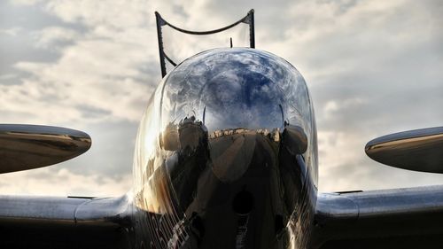 Close-up of airplane flying against sky