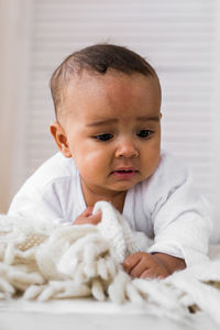 Portrait of cute baby boy on bed