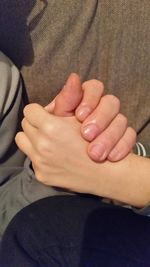 Close-up of cropped hand holding baby