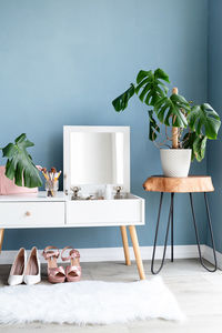 Stylish room interior with elegant dressing table and plants