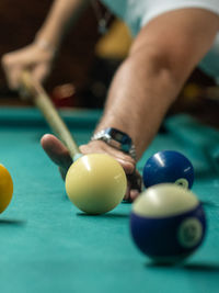Cropped hand playing pool