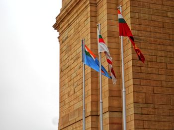 Low angle view of flags of different defence forces hanging against india gate