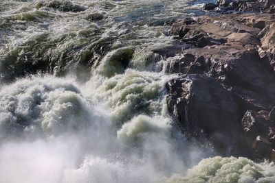 High angle view of water flowing through rocks