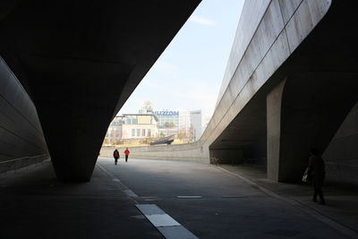 People walking on bridge in city