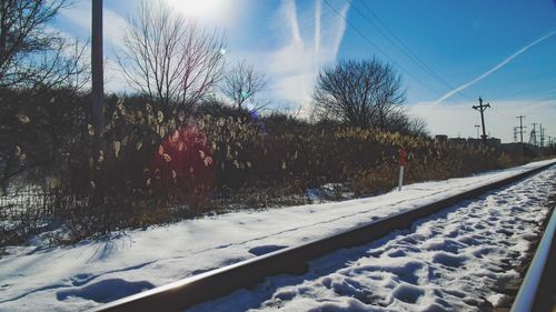 Road passing through snow covered landscape