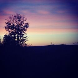 Silhouette landscape against sky at sunset