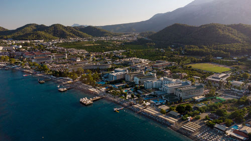 High angle view of townscape by sea against sky