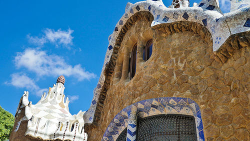 Low angle view of statues on building against sky