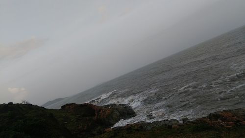 Scenic view of foggy landscape against sky