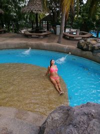 Man surfing in swimming pool