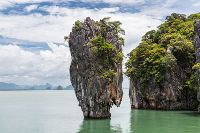 Panoramic view of rock formation amidst sea against sky