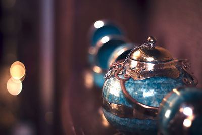 Close-up of illuminated lighting equipment hanging on table