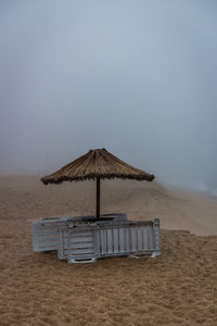 Lifeguard hut on beach against clear sky