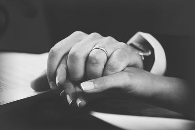 Cropped groom holding hands of bride