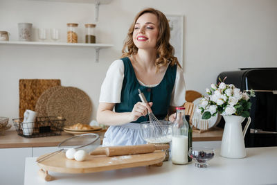 Pretty adult girl cooking in the kitchen