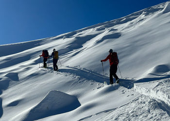 People skiing on snowcapped mountain