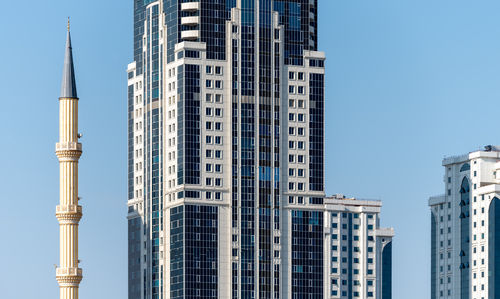 Low angle view of skyscrapers against clear sky