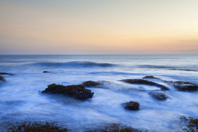 Scenic view of sea against sky during sunset